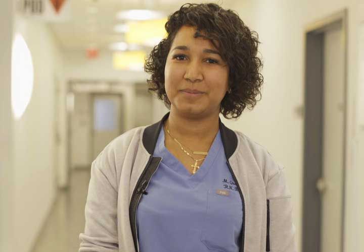 a female nurse smiling at the camera