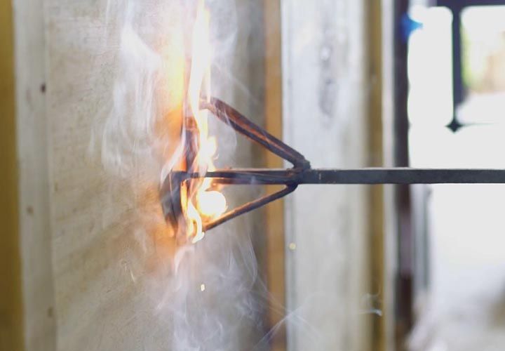 a glassmaker branding a shipping container