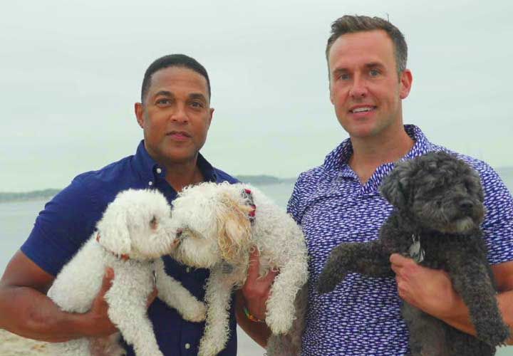 Don Lemon holding his dog at the beach